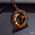 Load image into Gallery viewer, Leo zodiac star sign glass and wood pendant necklace on faux leather cord
