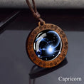 Load image into Gallery viewer, Capricorn zodiac star sign glass and wood pendant necklace on faux leather cord

