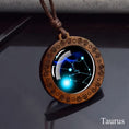 Load image into Gallery viewer, Taurus zodiac star sign glass and wood pendant necklace on faux leather cord
