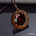 Load image into Gallery viewer, Cancer zodiac star sign glass and wood pendant necklace on faux leather cord
